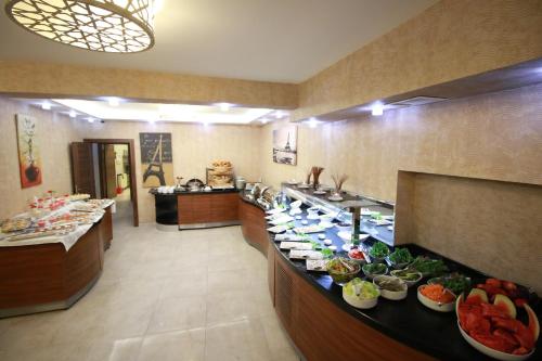 a buffet line in a restaurant with plates of food at Business Han Hotel in Nevsehir