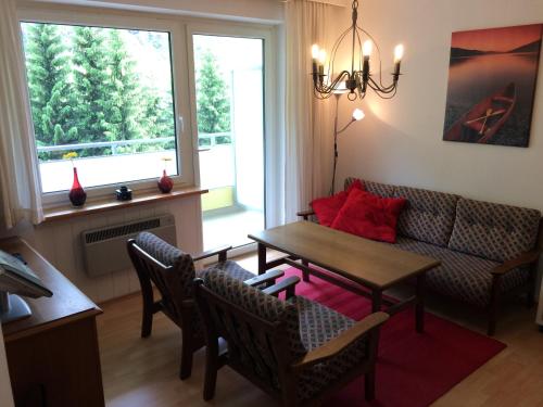 ein Wohnzimmer mit einem Tisch und einem Sofa in der Unterkunft Lärchenhof Apartment Nr 8 in Innerkrems