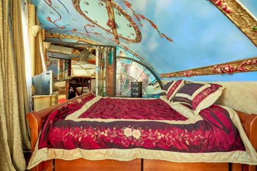 a bedroom with a bed in a room with a painting at Dali Apartments in Skopje