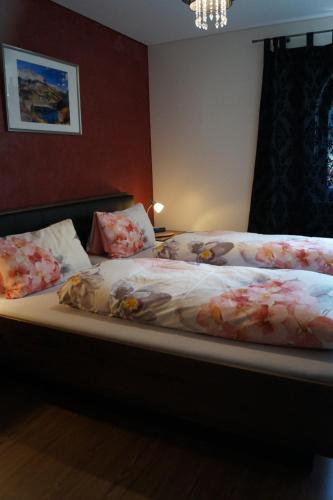 a bedroom with two beds with flowers on them at Landhaus Luzia in Wald am Arlberg