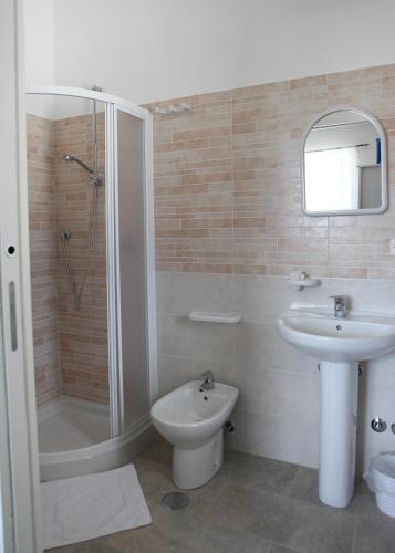 a bathroom with a shower and a toilet and a sink at B&B Masseria Cozzi in Lauria Inferiore