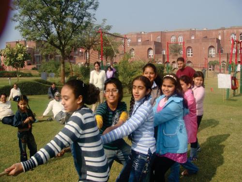 a group of children posing for a picture in a park at Magsons Resorts in Vrindāvan