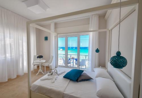 a bedroom with a bed with a view of the ocean at B&b Lungomare Otranto in Otranto