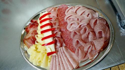 a plate filled with different types of food on a table at Apart Felsenhof in Längenfeld
