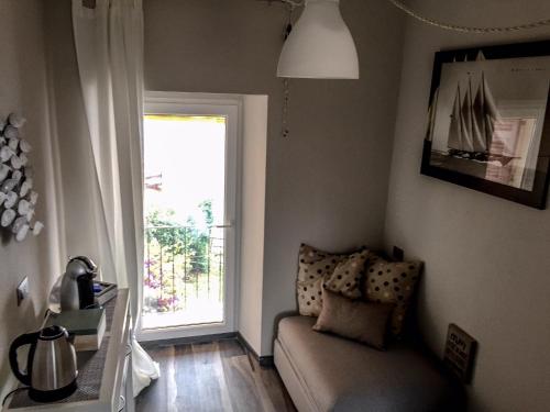 a living room with a couch and a window at Le Storie di Manarola in Manarola