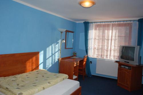 Кровать или кровати в номере Penzion Charlie