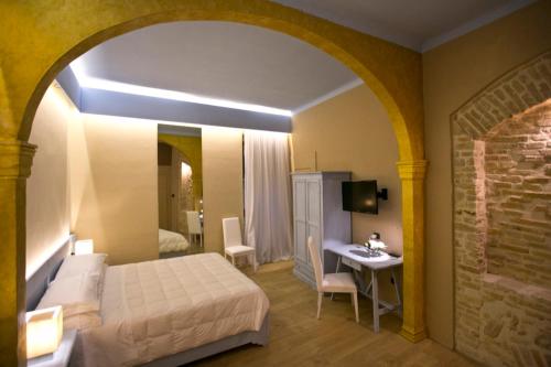 1 dormitorio con 1 cama y 1 mesa en una habitación en Bed and Breakfast Mameli 67, en Montefalco