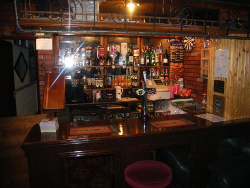 a bar in a pub with a lot of alcohol at The Roman Hotel in Blackpool