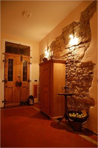 a living room with a stone wall and a table at Hotel & Café Mohrenbrunnen in Eisenberg