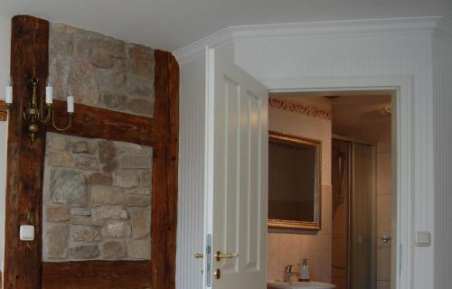 a bathroom with a stone wall and a sink at Hotel & Café Mohrenbrunnen in Eisenberg