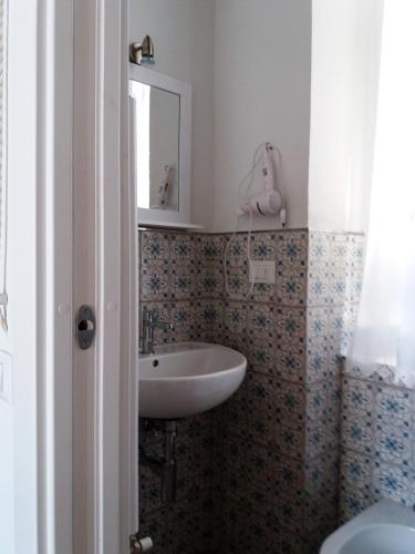 a bathroom with a sink and a mirror at IL PRINCIPINO B&B in Massa