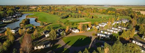 an aerial view of a golf course with a river at Augusta Dreams in Tydd Saint Giles