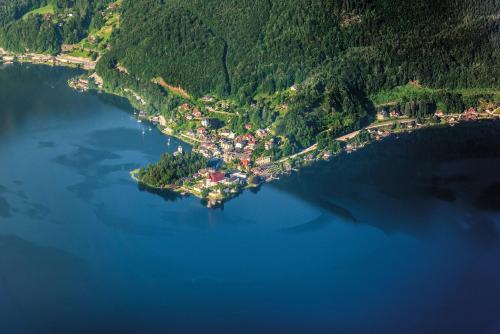 an island in the middle of a large body of water at Das Traunsee - Das Hotel zum See 4 Stern Superior in Traunkirchen
