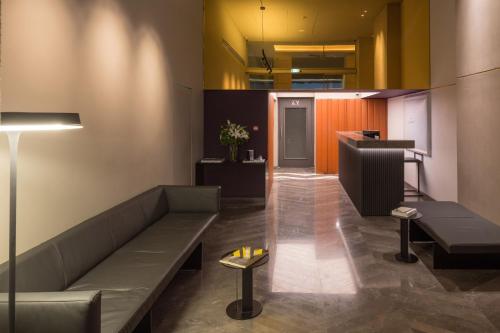 a living room with a couch and a bar at Hotel Lozenge in Athens