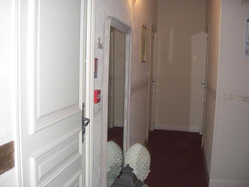 a hallway with a door open to a hallway with a room at La Marjolaine in Juan-les-Pins