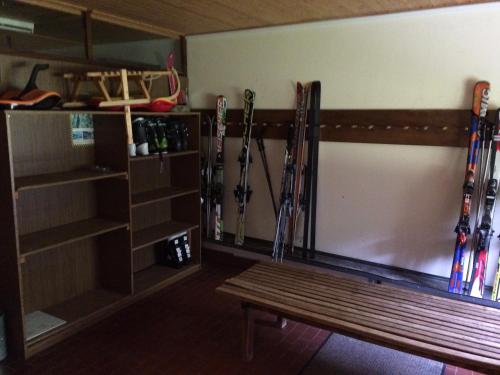 a bench in a room with skis leaned against a wall at Lärchenhof Apartment Nr 8 in Innerkrems