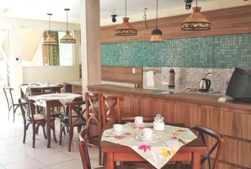 a restaurant with tables and chairs and a counter at Pousada Musleh in Rio Grande