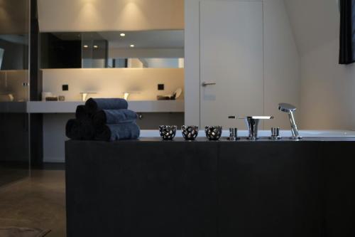 a kitchen with a counter with towels and a sink at B&B For 2-Wellness For 2 in Bruges