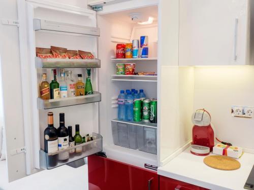 an open refrigerator filled with bottles and drinks at TOP CENTER LUXURY Apartment in Gabrovo