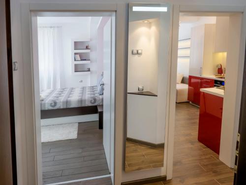 a bathroom with a door leading to a bedroom at TOP CENTER LUXURY Apartment in Gabrovo