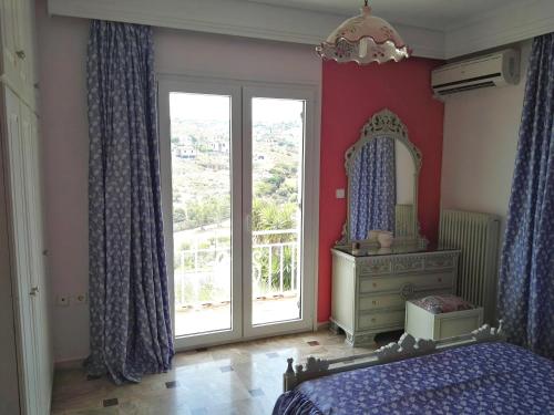 a bedroom with a mirror and a bed and a dresser at Katerina's house in Kalopigado