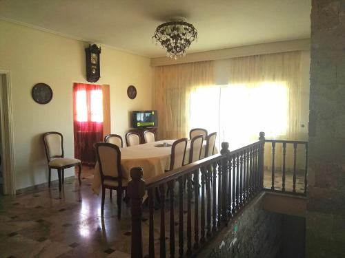 a dining room with a table and chairs and a window at Katerina's house in Kalopigado