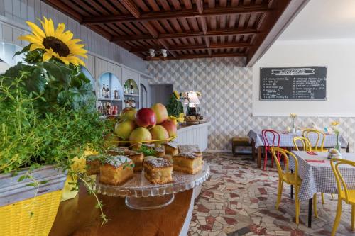 a table with cakes and apples on it in a restaurant at Hotel Gryf in Kościerzyna