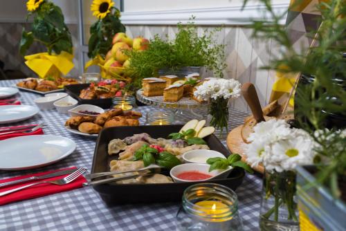 a table topped with plates of food on a table at Hotel Gryf in Kościerzyna