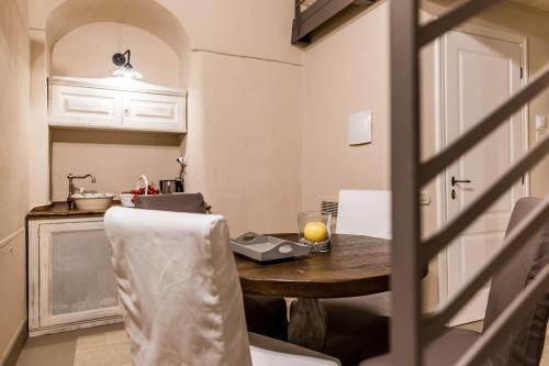 a kitchen with a table and chairs and a table and a counter at Borgo San Gaetano in Bernalda