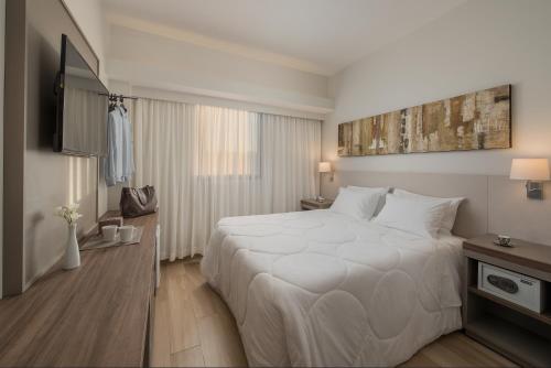 Ένα ή περισσότερα κρεβάτια σε δωμάτιο στο Hotel Nacional de Rio Preto - Distributed by Intercity