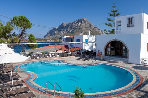 a pool at the hotel with a mountain in the background at Kalypso Studios in Myrties