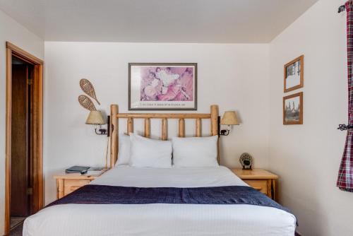 a bedroom with a bed and two tables with lamps at Franciscan Lodge in Tahoe Vista