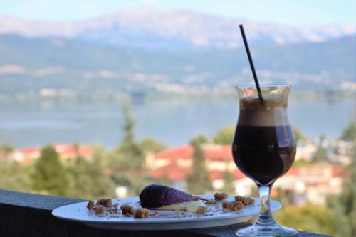 a plate of food and a drink on a table at SAZ City Life Boutique Hotel in Ioannina
