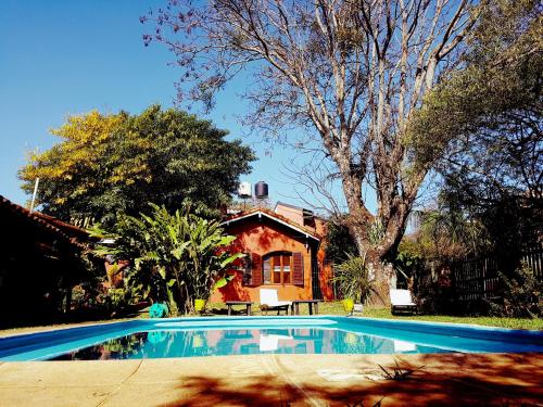 a swimming pool in front of a house at Hostel Iguazu Falls in Puerto Iguazú