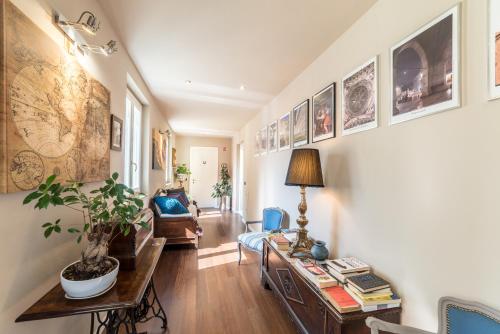 a living room with a couch and a table at Domus San Martino GuestHouse in Piacenza