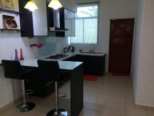 a kitchen with a counter and a stove top oven at Homestay As SyifaMuslimOnly Changlun in Changlun