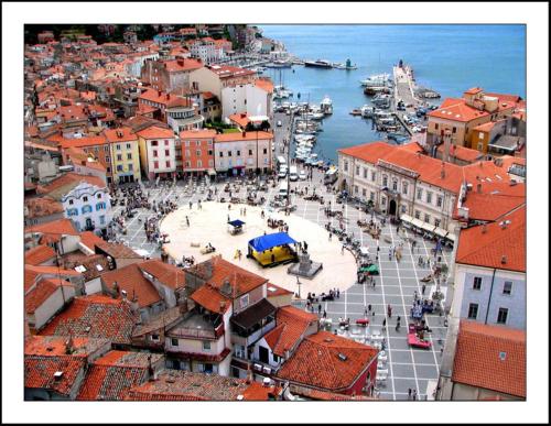 an aerial view of a city with buildings and a harbor at Floating Sea Houses MARINA LUX in Portorož