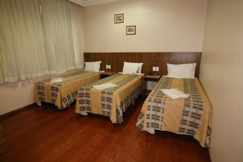 Tempat tidur dalam kamar di Hotel Presidente Ipatinga