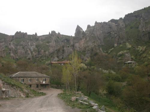 a dirt road in front of a mountain at NarVar Hotel in Goris