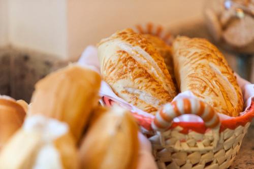 a basket filled with sandwiches on top of a table at Pousada Quatro Estacoes in Trindade