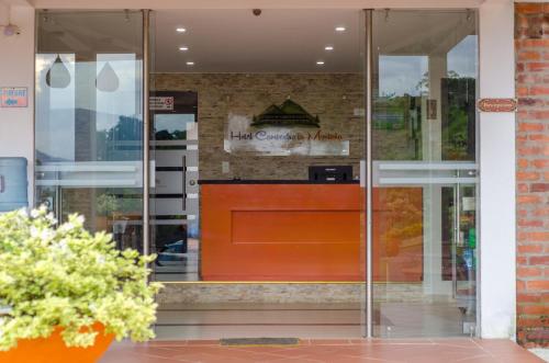 a glass door of a store with a sign on it at Hotel La Montaña San Gil in San Gil