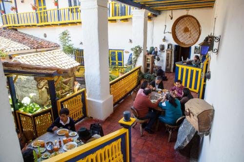 a group of people sitting at a table in a restaurant at Hotel Museo la Posada del Molino in El Cocuy