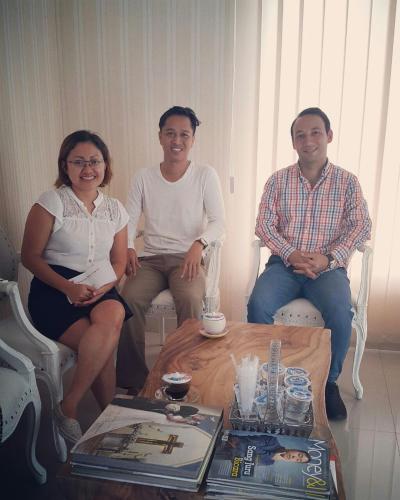 a group of three people sitting around a table at Wika Bali Beach House in Jimbaran