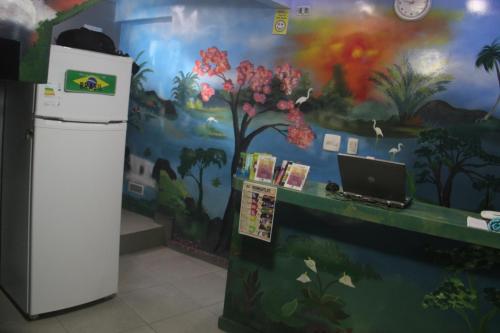 a room with a wall with a mural of flowers at Hostel Yes Brasil in Rio de Janeiro
