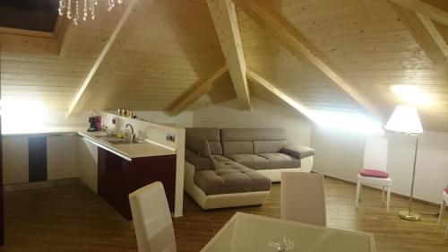 a kitchen and living room with a couch and a table at I Monili in Moneglia