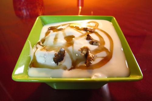 a green plate with a dessert with nuts on it at Kevin's Trekker Inn in Shangri-La