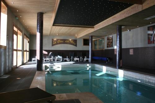 a swimming pool in a building with a restaurant at Chalet des Neiges : La Cime Des Arcs in Arc 2000