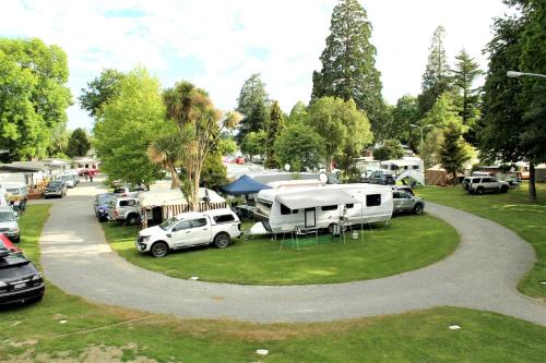 a group of vehicles parked in a parking lot at Geraldine TOP 10 Holiday Park in Geraldine