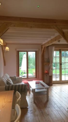 a living room with a couch and a table at WillowTree Cottage in Avèze