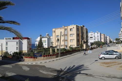a city street with cars parked on the street at Kasgar Court Hotel in Karaoğlanoğlu